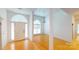 Foyer with hardwood flooring, white walls, a front door, and archways leading to other rooms at 1337 Braeburn Nw Rd, Concord, NC 28027