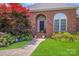 Inviting front entrance featuring a brick facade, manicured landscaping, and a stylish front door at 1337 Braeburn Nw Rd, Concord, NC 28027