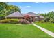 Well-maintained brick home with a manicured lawn, beautiful landscaping, and a welcoming entrance at 1337 Braeburn Nw Rd, Concord, NC 28027