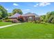 Well-maintained brick home with a manicured lawn, beautiful landscaping, and a welcoming entrance at 1337 Braeburn Nw Rd, Concord, NC 28027
