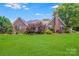 Lovely brick home with a well-kept lawn, charming landscaping, and a classic architectural style at 1337 Braeburn Nw Rd, Concord, NC 28027
