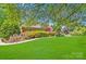 Charming brick home with a lush green front yard and mature trees, perfect for outdoor enjoyment at 1337 Braeburn Nw Rd, Concord, NC 28027