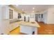 Bright and spacious kitchen features white cabinetry, granite countertops, and a functional island at 1337 Braeburn Nw Rd, Concord, NC 28027