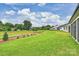 Expansive backyard with lush green grass, landscaping, and view of neighboring houses at 13605 Tranquil Day Dr, Matthews, NC 28105