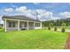 Exterior of home showing the screened-in porch and expansive green backyard at 13605 Tranquil Day Dr, Matthews, NC 28105