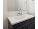 Close-up of a bathroom vanity with a black cabinet and a white countertop at 13605 Tranquil Day Dr, Matthews, NC 28105