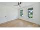 Bright bedroom features hardwood floors, two windows, and ceiling fan at 13605 Tranquil Day Dr, Matthews, NC 28105