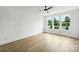 Bright and airy bedroom with hardwood floors, ceiling fan, and large windows at 13605 Tranquil Day Dr, Matthews, NC 28105