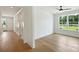 Bright bedroom with light hardwood floors and a large window at 13605 Tranquil Day Dr, Matthews, NC 28105