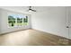 Bright bedroom with large windows, ceiling fan, and hardwood floors at 13605 Tranquil Day Dr, Matthews, NC 28105