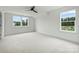 Large bedroom featuring windows, ceiling fan, and carpet at 13605 Tranquil Day Dr, Matthews, NC 28105