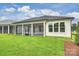 Exterior of home showcasing the screened-in porch and well-maintained lawn at 13605 Tranquil Day Dr, Matthews, NC 28105