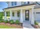 Inviting front porch with white columns and a view of the landscaped front yard at 13605 Tranquil Day Dr, Matthews, NC 28105