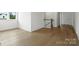 Hallway features hardwood floors, windows, and white walls at 13605 Tranquil Day Dr, Matthews, NC 28105