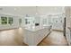 Island kitchen with stainless appliances, bar seating, and an open layout to the living area at 13605 Tranquil Day Dr, Matthews, NC 28105