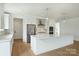 Open kitchen design with stainless steel appliances, large center island, and custom cabinetry at 13605 Tranquil Day Dr, Matthews, NC 28105