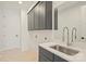 Laundry Room featuring sink, dark cabinets, and mirror at 13605 Tranquil Day Dr, Matthews, NC 28105