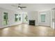 Bright living room with light hardwood floors, a fireplace, and large windows at 13605 Tranquil Day Dr, Matthews, NC 28105