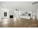 Bright open-concept living room featuring a modern fireplace and hardwood floors at 13605 Tranquil Day Dr, Matthews, NC 28105