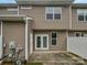 Private outdoor patio area, perfect for relaxing or entertaining, with neutral siding and a fenced yard at 14056 Lyon Hill Ln, Huntersville, NC 28078
