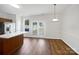 Open dining area with stainless steel appliances, island with counter seating, and a glass door at 14056 Lyon Hill Ln, Huntersville, NC 28078