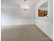 A dining room with carpet flooring, white walls, and a classic chandelier at 14056 Lyon Hill Ln, Huntersville, NC 28078