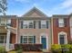 Charming townhome with a well-maintained facade, featuring blue shutters and a quaint front garden at 14056 Lyon Hill Ln, Huntersville, NC 28078
