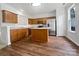 Well-lit kitchen with stainless steel appliances, light countertops, and wood-look flooring at 14056 Lyon Hill Ln, Huntersville, NC 28078