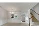 Spacious living room with elegant crown molding, staircase, and open archway to the dining area at 14056 Lyon Hill Ln, Huntersville, NC 28078