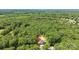 Aerial view shows secluded home in a lush green forest at 1408 Bloomsberry Ln, Waxhaw, NC 28173