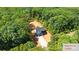Aerial view of home site shows home surrounded by dense trees at 1408 Bloomsberry Ln, Waxhaw, NC 28173