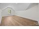 Finished attic space with hardwood floors and a large window at 1408 Bloomsberry Ln, Waxhaw, NC 28173