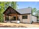 Expansive back porch with stylish lighting, natural wood accents, and sleek railing at 1408 Bloomsberry Ln, Waxhaw, NC 28173
