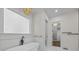 Bright bathroom featuring a freestanding tub, walk in closet, and marble floors at 1408 Bloomsberry Ln, Waxhaw, NC 28173