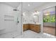 Modern bathroom with double vanity, marble tile, walk-in shower, and glass door at 1408 Bloomsberry Ln, Waxhaw, NC 28173