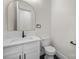 Stylish powder room featuring a modern vanity, gold-framed mirror, and sleek fixtures at 1408 Bloomsberry Ln, Waxhaw, NC 28173