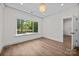 Sunlit bedroom featuring hardwood floors and a large window overlooking the neighborhood at 1408 Bloomsberry Ln, Waxhaw, NC 28173
