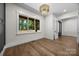 Bright bedroom with wood floors, modern light fixture, decorative wall trim, and large window at 1408 Bloomsberry Ln, Waxhaw, NC 28173