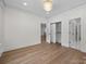 Bright bedroom showcasing wood flooring, neutral walls, and closet space at 1408 Bloomsberry Ln, Waxhaw, NC 28173