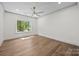 Bedroom featuring hardwood floors, a ceiling fan, and a sunlit window at 1408 Bloomsberry Ln, Waxhaw, NC 28173