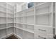 Custom walk-in closet with built-in shelving and drawers, offering ample storage space and organization at 1408 Bloomsberry Ln, Waxhaw, NC 28173