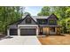 Stunning two-story home with a three car garage, modern farmhouse design, and covered front porch at 1408 Bloomsberry Ln, Waxhaw, NC 28173
