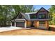 Charming two-story home with a 3 car garage, stone accents, and inviting covered front porch at 1408 Bloomsberry Ln, Waxhaw, NC 28173