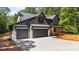 Beautiful two-story home featuring a 3-car garage, modern design, and well-manicured lawn at 1408 Bloomsberry Ln, Waxhaw, NC 28173
