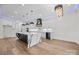 Modern kitchen boasts a large island with waterfall countertops, stainless steel appliances, and custom lighting at 1408 Bloomsberry Ln, Waxhaw, NC 28173