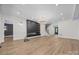 Bright open living room featuring a fireplace, hardwood floors, staircase, and modern chandelier at 1408 Bloomsberry Ln, Waxhaw, NC 28173