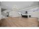 Expansive open living room boasts hardwood floors and direct access to the modern kitchen and staircase at 1408 Bloomsberry Ln, Waxhaw, NC 28173