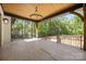 Expansive covered porch boasts wood ceiling, chandelier, and wooded views at 1408 Bloomsberry Ln, Waxhaw, NC 28173