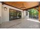 Open-air porch showcases wood ceiling and chandelier with sliding glass doors at 1408 Bloomsberry Ln, Waxhaw, NC 28173
