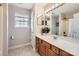Well-lit bathroom featuring double mirrors, ample countertop space, and a clean, modern design at 1455 Moss Creek Dr, Harrisburg, NC 28075